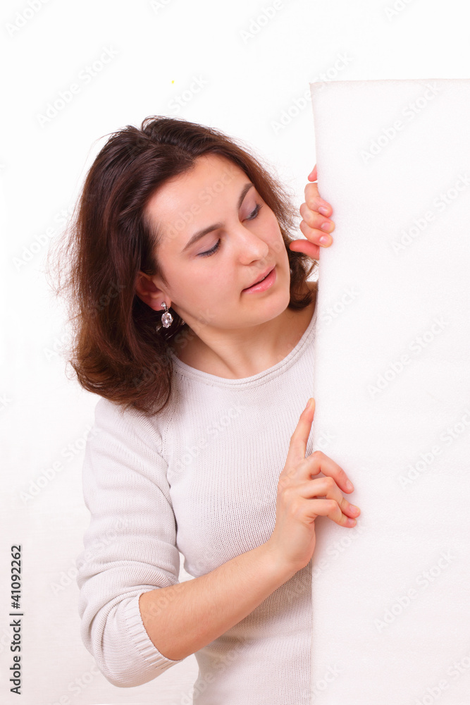 Beautiful young girl looks at a piece of paper Beautiful young girl looks at a piece of paper