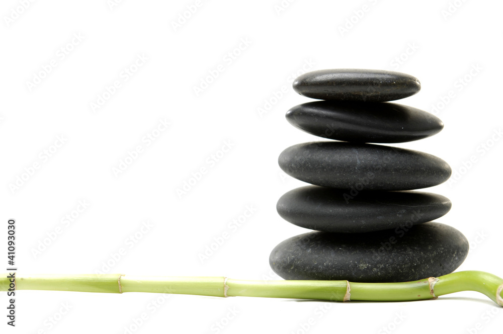 Isolated lucky bamboo stick and stacked black stones Isolated lucky bamboo stick and stacked black stones