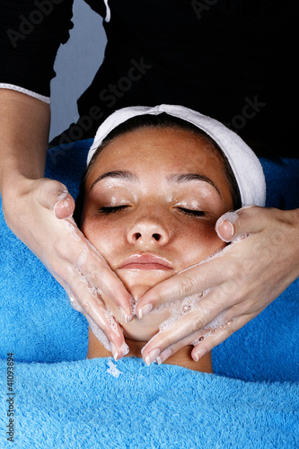 Young girl getting a facial
