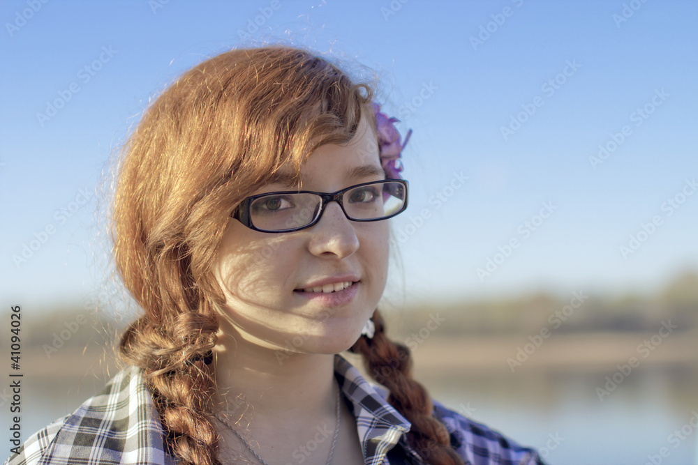 Portrait of the red-haired girl on river bank Portrait of the red-haired girl on river bank