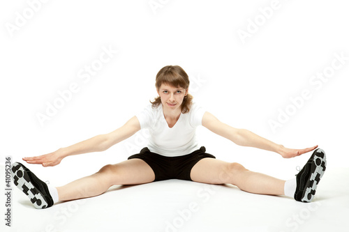 Young woman doing sport exercises; white background