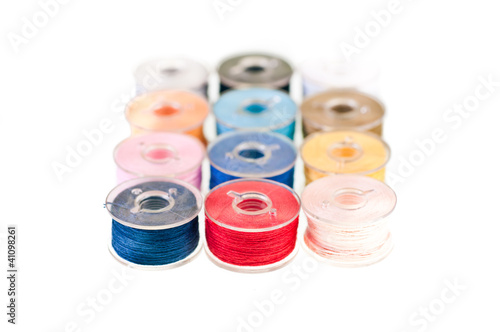 row of colorful bobbin thread