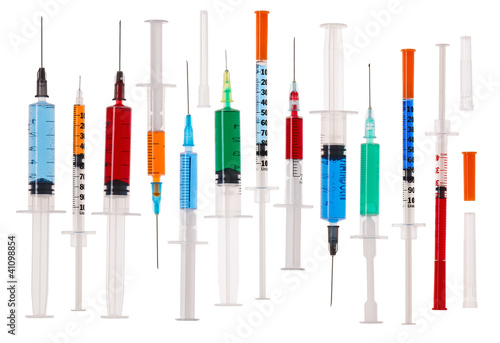 Many multicolor syringes isolated on white