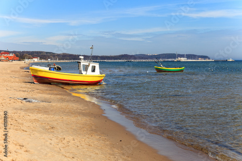 Fishing boats on the background of the pier in Sopot, Poland.