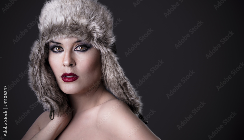 A sensual female green-eyed woman with fur hat, winter concept A sensual female green-eyed woman with fur hat, winter concept