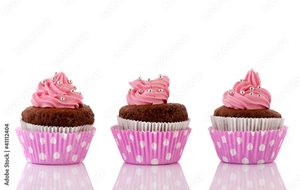 Three Chocolate cupcakes with pink butter icing Three Chocolate cupcakes with pink butter icing