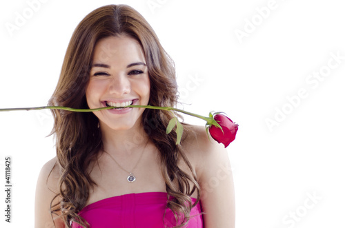 Beautiful woman holding a rose in her mouth