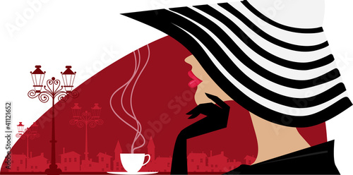 Stylish woman in a big hat at cafe