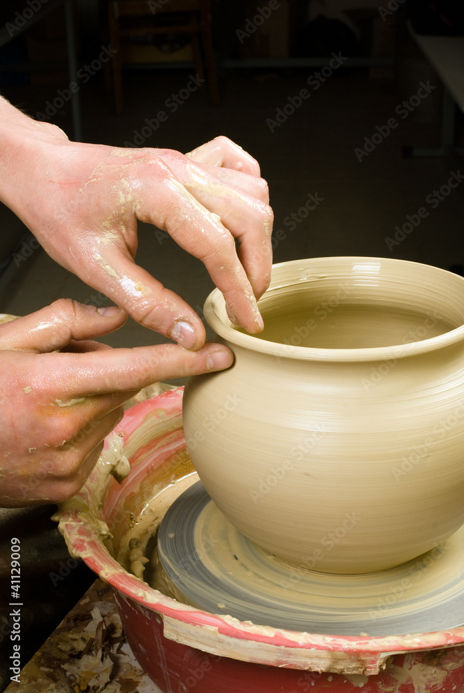 hands of a potter, creating an earthen jar of white clay hands of a potter, creating an earthen jar of white clay