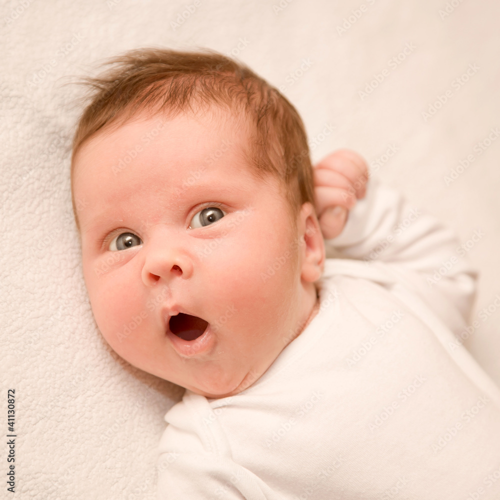 surprised newborn baby with open mouth