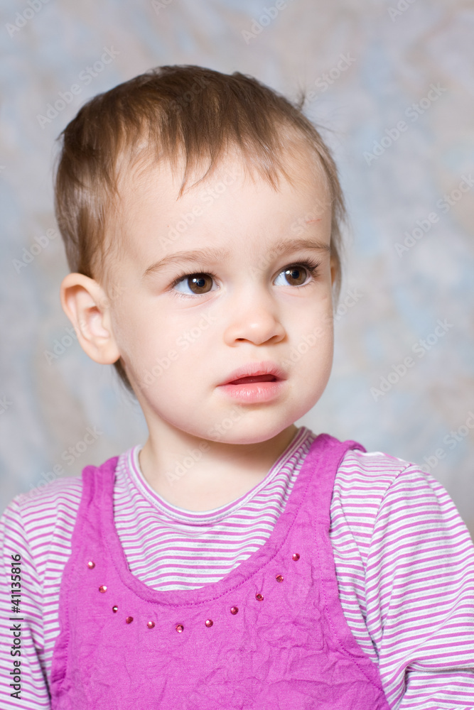 The child in a pink dress with toys The child in a pink dress with toys