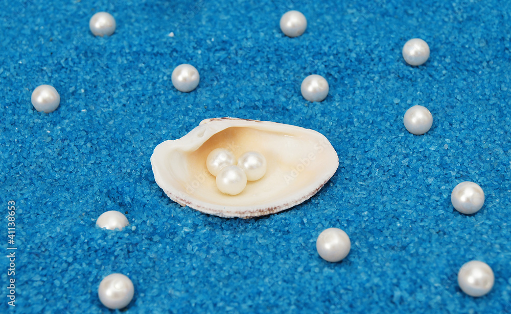 Beautiful shell and pearls around it,on rocky blue background Beautiful shell and pearls around it,on rocky blue background