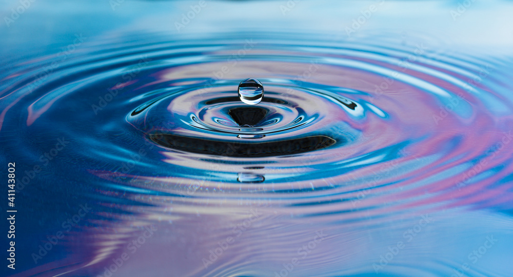 Drop of pure fresh water falls in water Drop of pure fresh water falls in water