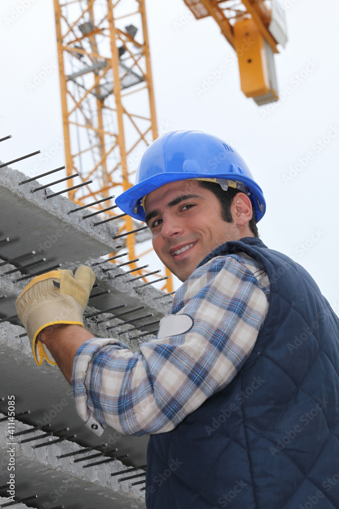 Fototapeta premium Construction worker with slabs of reinforced concrete