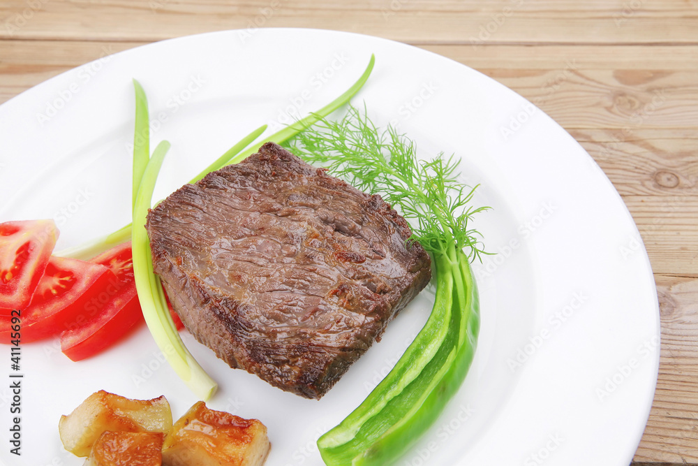 meat food : roasted fillet mignon on white plate with tomatoesan