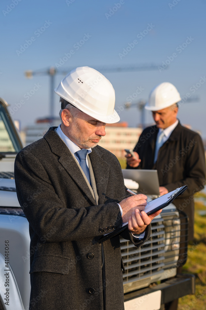 Architect man make notes on construction site Architect man make notes on construction site
