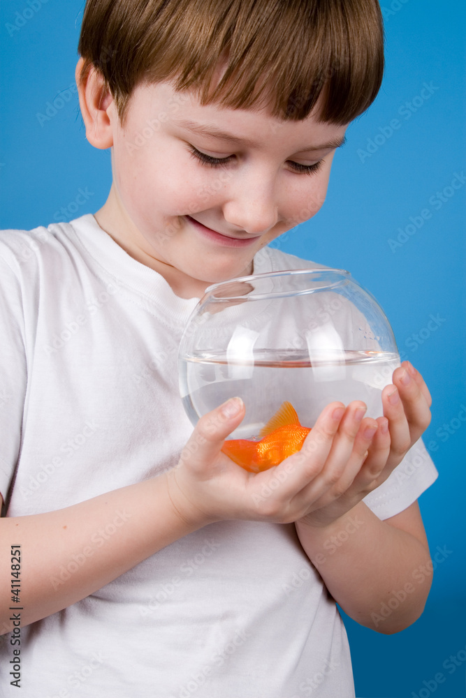 Boy holds a fishbowl with a goldfish