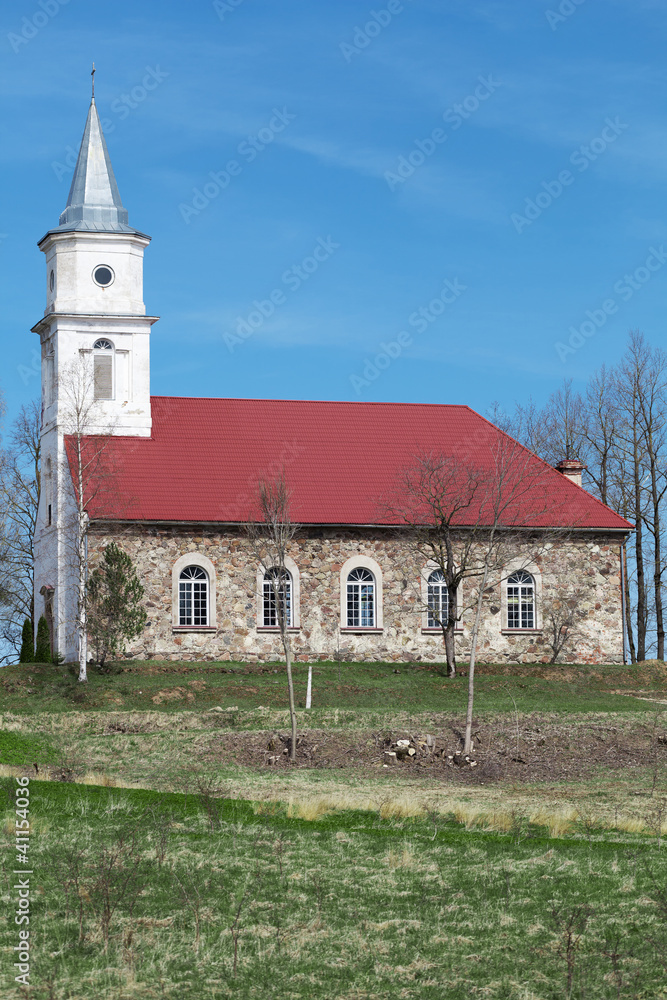 Old rural church on the blue sky background