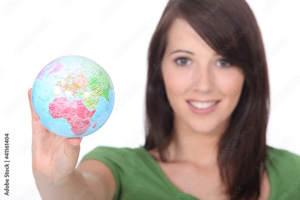 young woman holding out world globe young woman holding out world globe