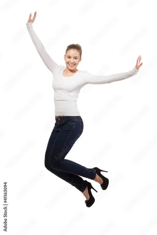 Casual woman jumping in joy ? isolated over a white background