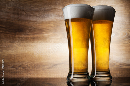 Two glass beer on wood background with copyspace