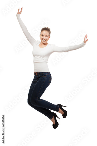 Casual woman jumping in joy ? isolated over a white background