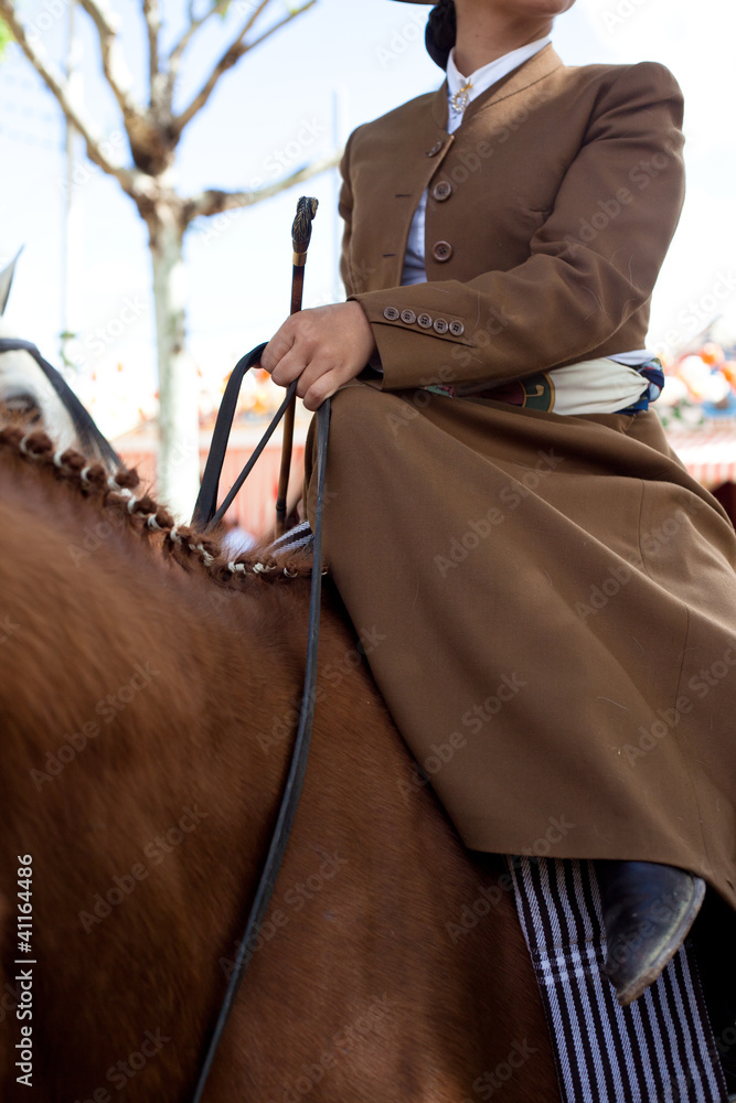 Horse woman wearing the traditional spanish traje corto