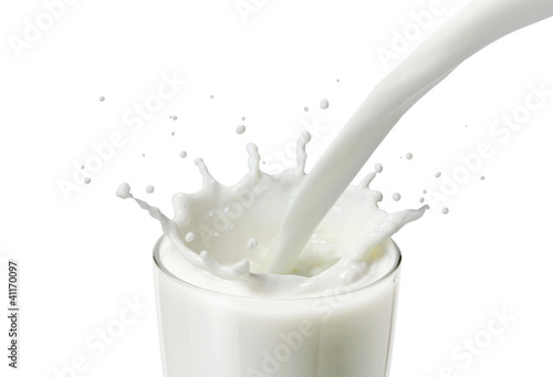 pouring milk or white liquid in a glass created splash
