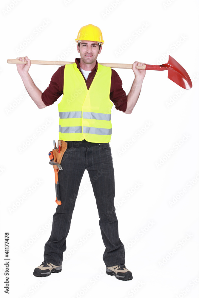 bricklayer standing legs apart carrying shovel bricklayer standing legs apart carrying shovel