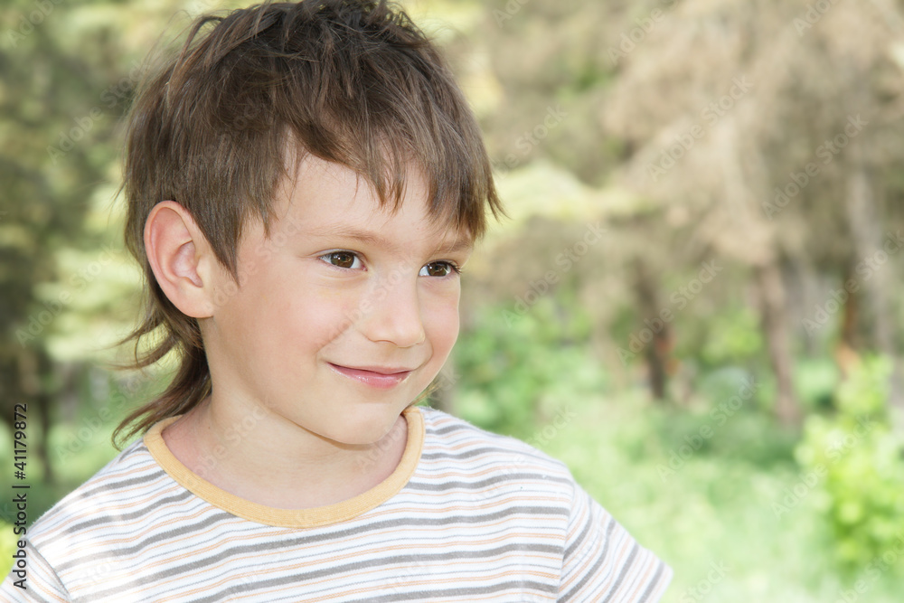 young smiling boy on natural background