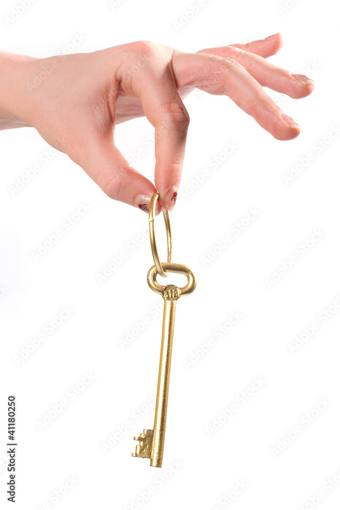 Fingers holding Golden key isolated over white Fingers holding Golden key isolated over white