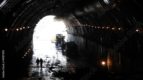 People in a tunnel. Building site.