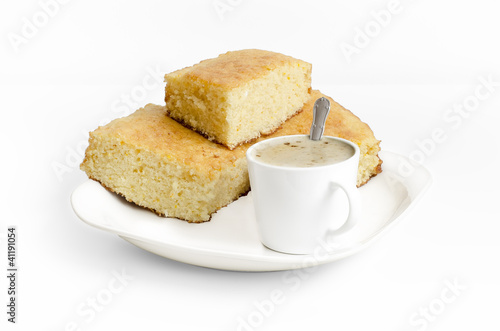 Sponge cake and a cup of coffe on white background