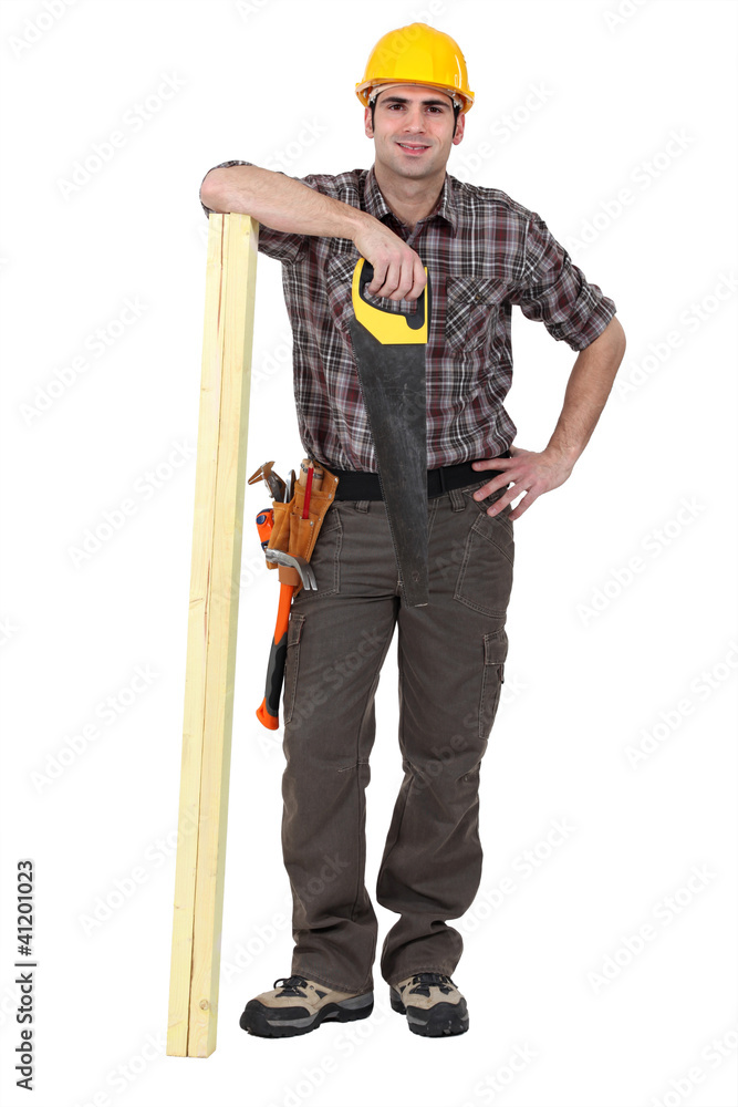 Tradesman posing with his tools and building materials Tradesman posing with his tools and building materials