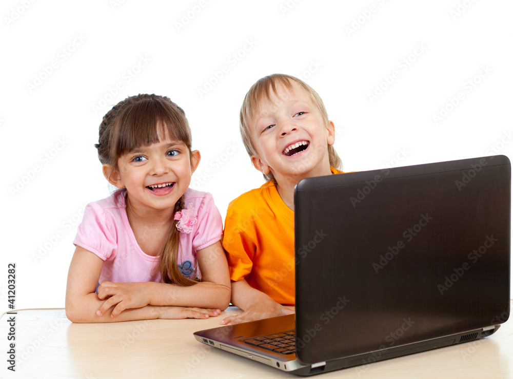 Funny children using a laptop over white background Funny children using a laptop over white background