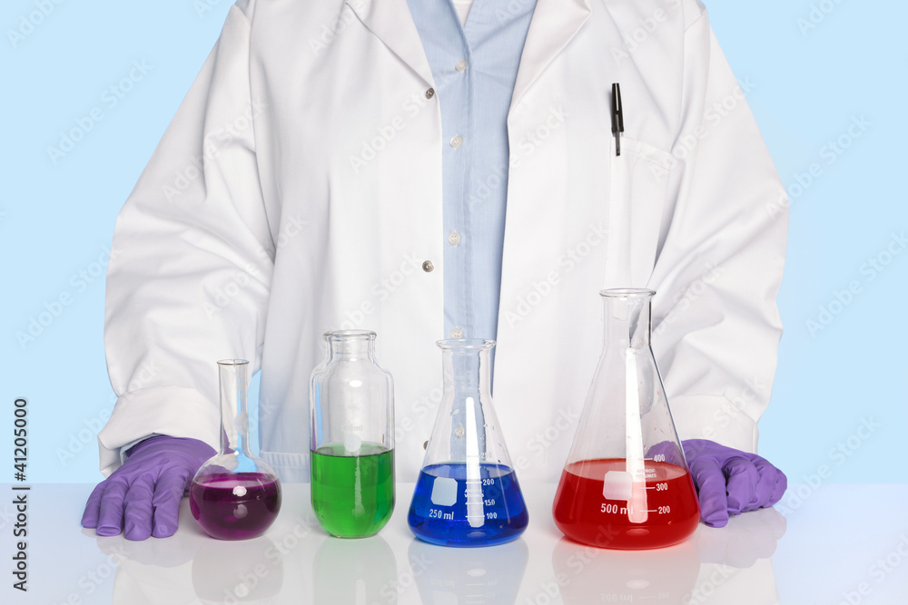 Fototapeta premium Chemist standing at a desk with chemicals