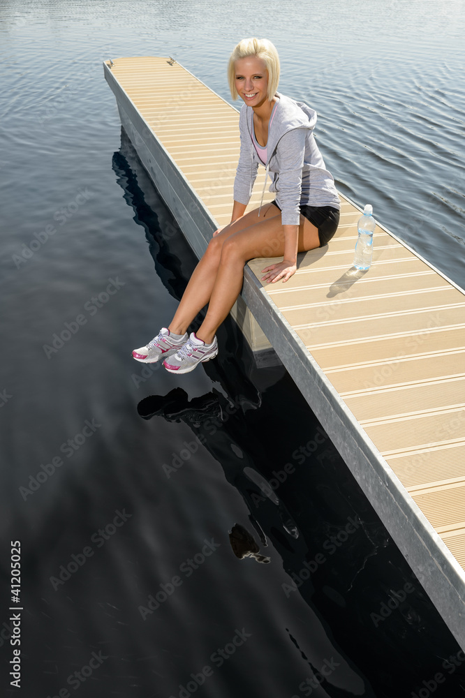 Young sport woman relax on pier water