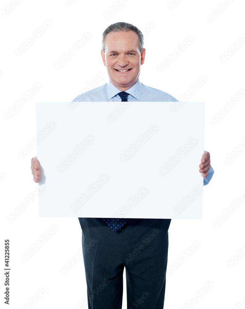 Handsome man holding blank white billboard Handsome man holding blank white billboard