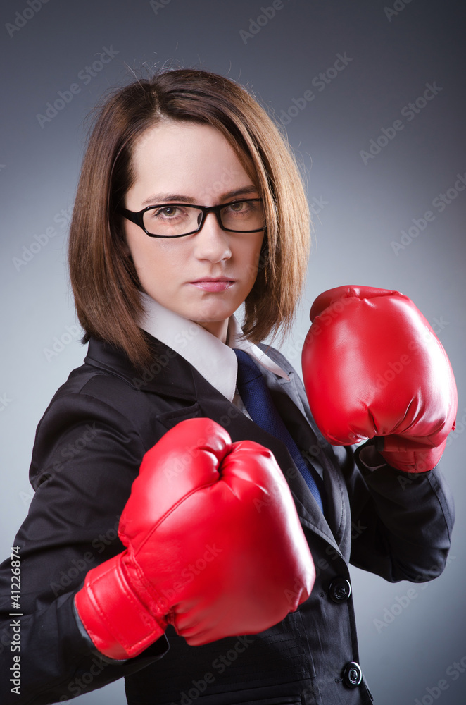 Young businesswoman in boxing concept Young businesswoman in boxing concept