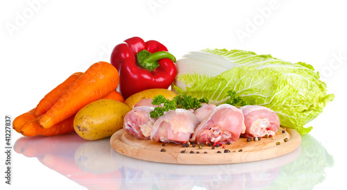 Fresh vegetables with raw chicken drumsticks and pork steak