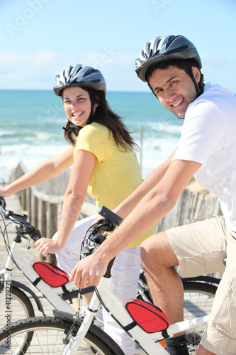 Young man and young woman having bike ride