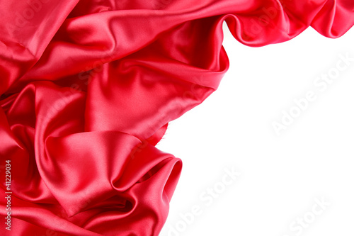 Red silk fabric material on white. Copy space