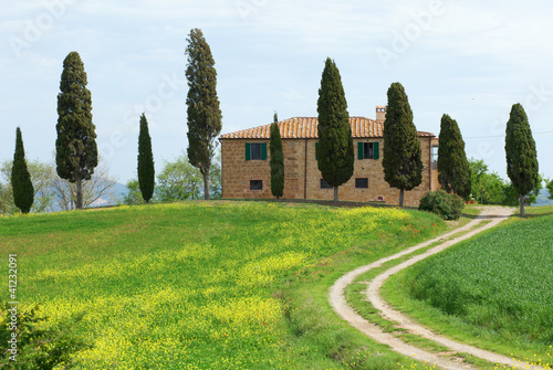 Typical Tuscany farmhouse with cupressus