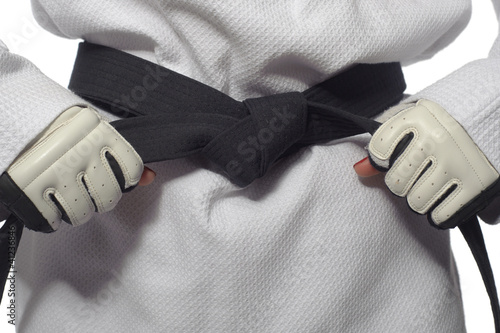 Woman in a kimono and belt and gloves for martial arts