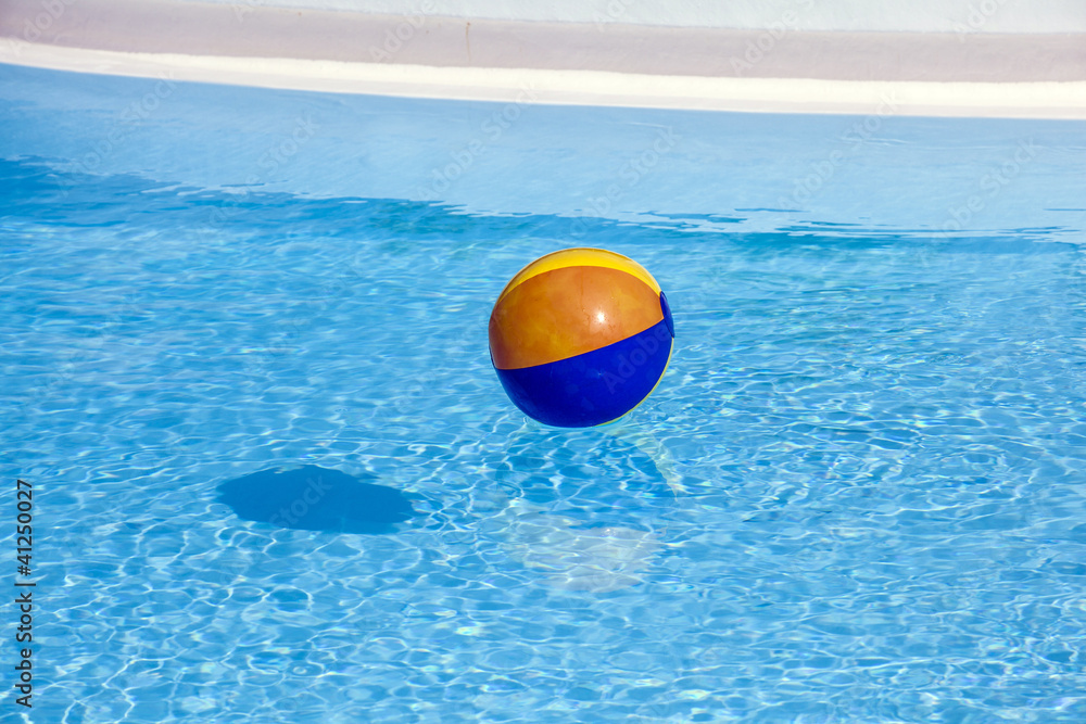 inflated plastic ball flying in the pool