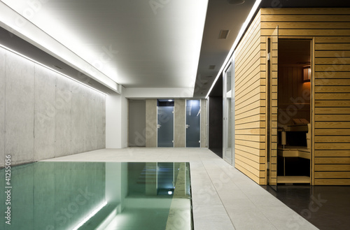 modern concrete house , indoor pool with sauna