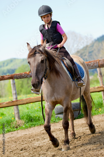 Horse riding - lovely girl is riding a horse
