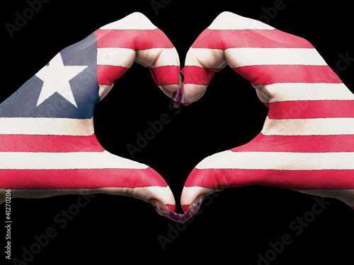 Heart and love gesture by hands colored in liberia flag for tour