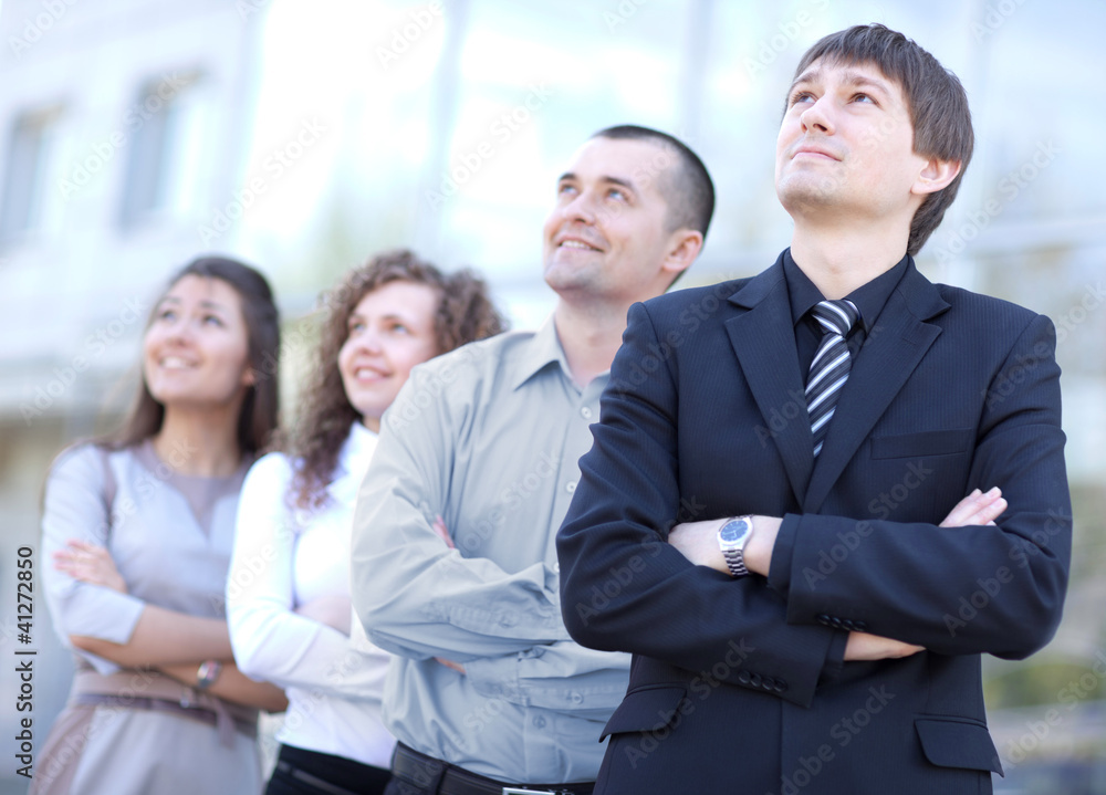 business team standing in a row at office and looking upwards business team standing in a row at office and looking upwards