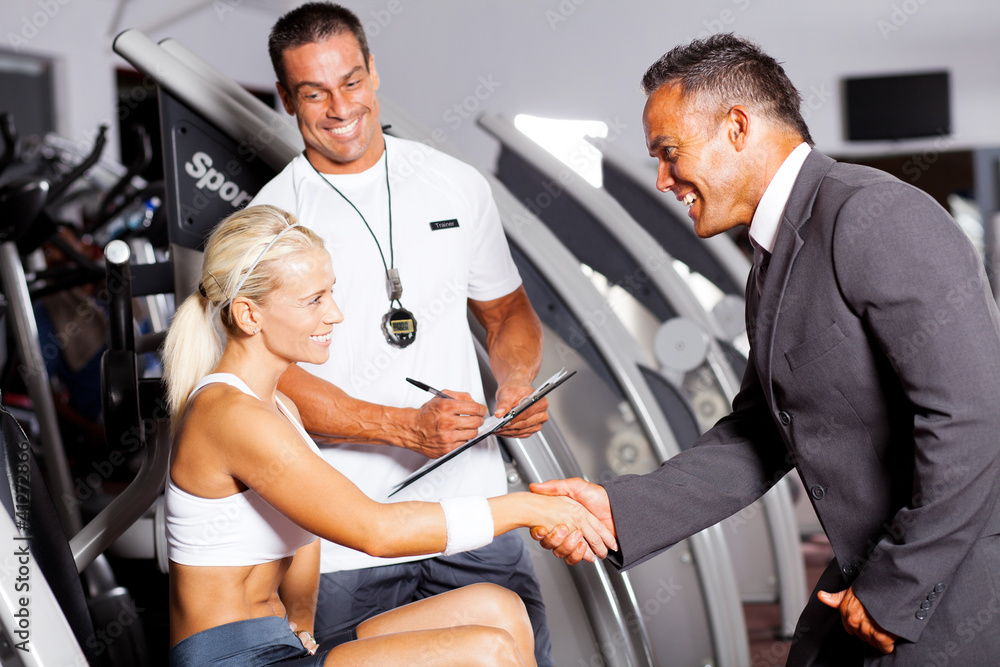 friendly gym manager greeting customer friendly gym manager greeting customer